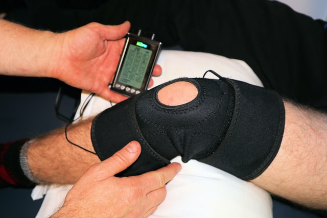 Physiotherapist treating a knee injury